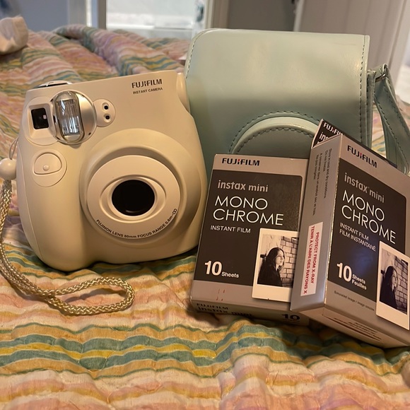 instax white camera with blue case and two packs of film